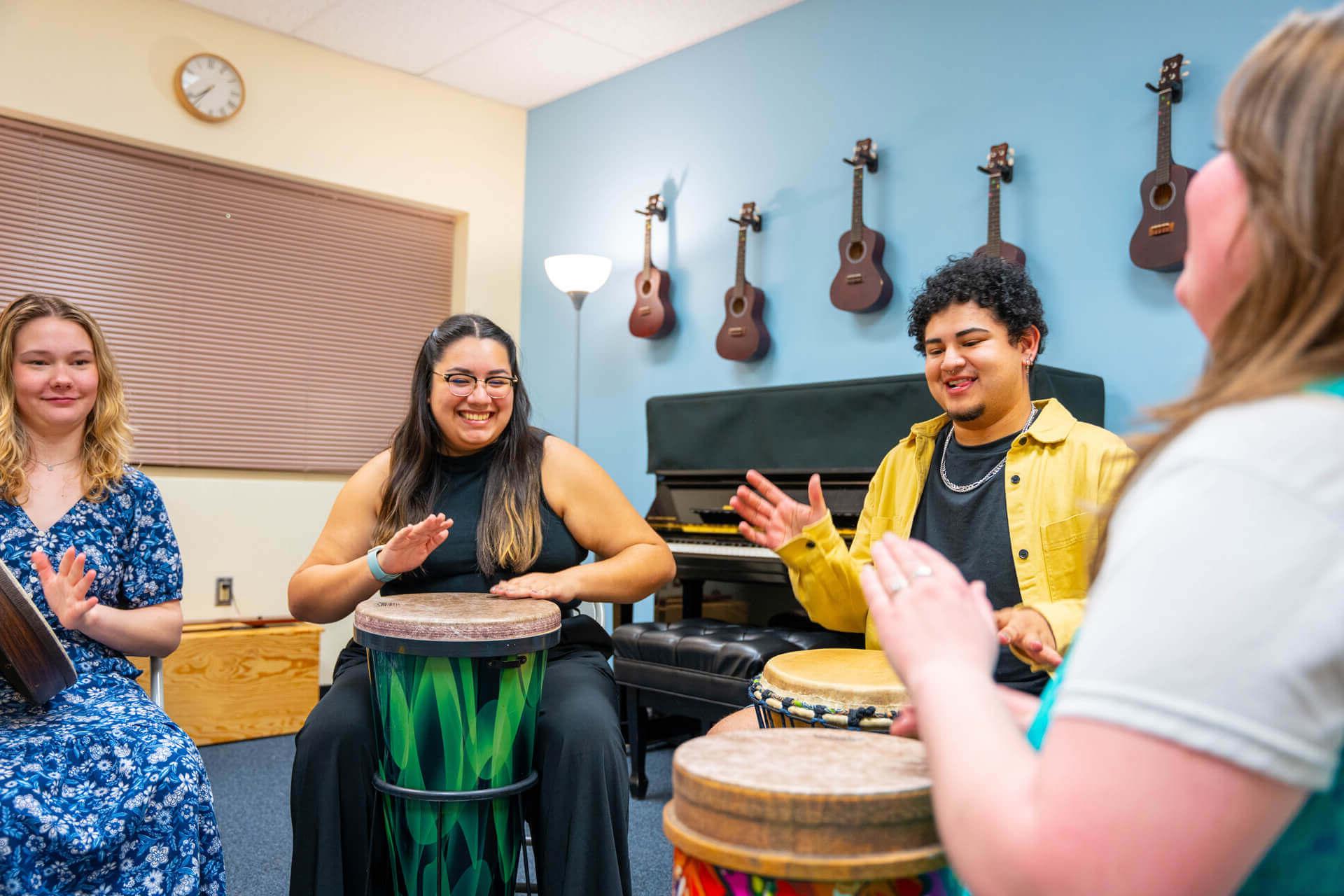 Students make music on drums in the Marion Sung Music Therapy Center